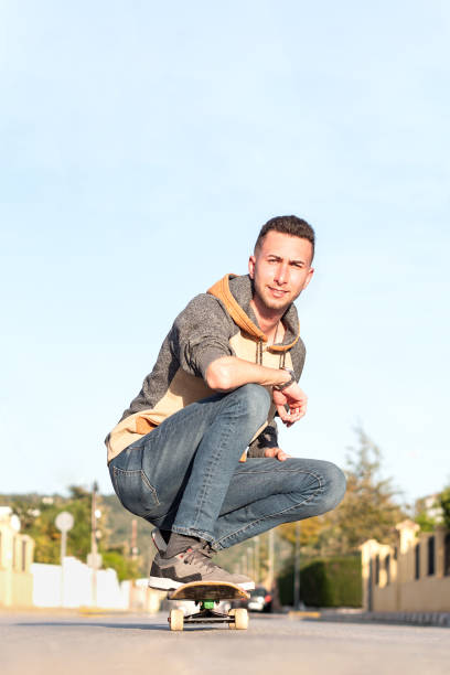 istock Young man posing with a skateboard in the street. Selective focus 1433151341