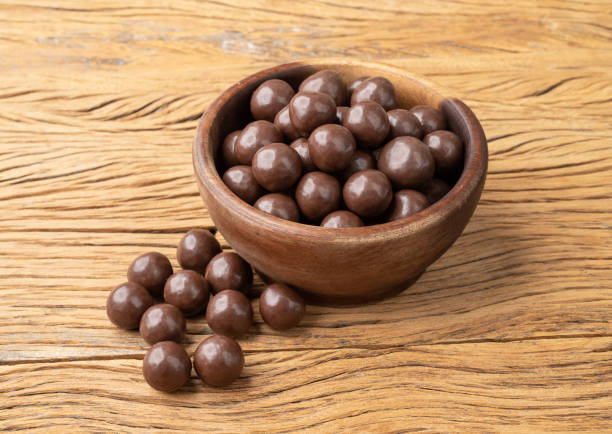 istock Chocolate malted balls on a bowl over wooden table 1433151671