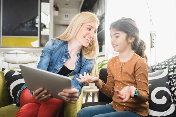 istock Happy mother and daughter using a digital tablet 1433154616