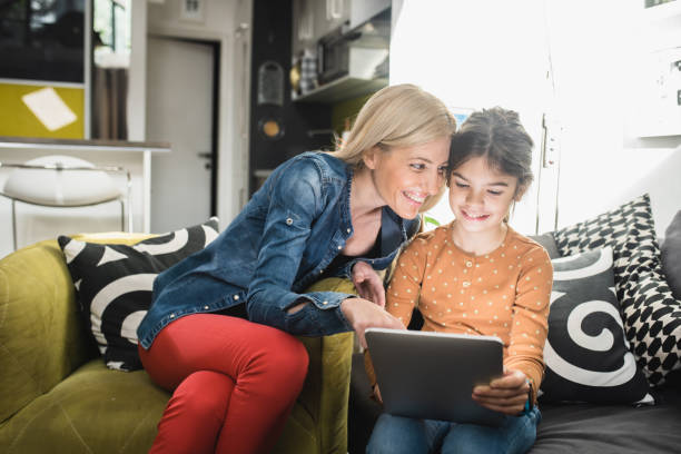 istock Happy mother and daughter using a digital tablet 1433154618