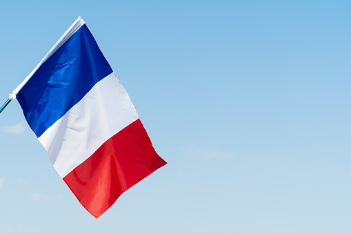 Flag of France waving in the wind in the sky