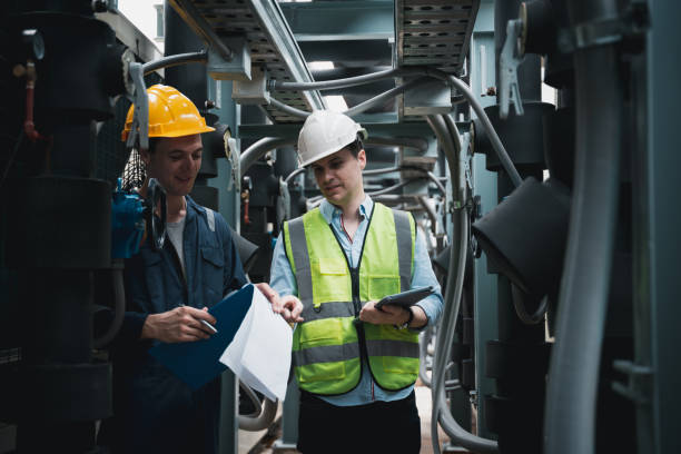 istock Engineer and team examining the air conditioning cooling system of a huge building or industrial site. 1433159777
