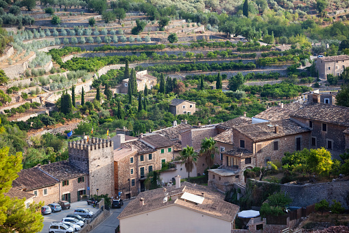 Fornalutx village is reputed to be the prettiest village in Spain. It is situated amongst the olive and orange groves of the Golden Valley, near Soller, on the island of Majorca in the Mediterranean. The Golden Valley offers an excellent climate for the growing of Oranges, Lemons and Olives, as can be seen here by some terraced groves adjacent to the village.