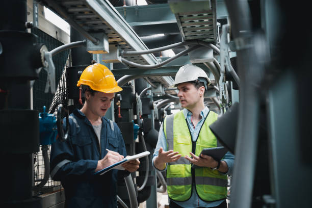 istock Engineer and team examining the air conditioning cooling system of a huge building or industrial site. 1433159961