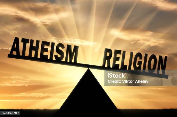 Word Religion Is More Powerful Than The Word Atheism On The Scales Stock Photo - Download Image Now