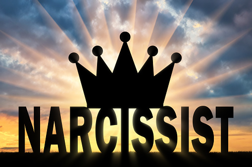 Silhouette of the Big Crown lies on the word Narcissist Concept of narcissistic people in society