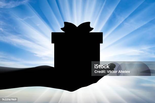 Altruism Silhouette Of A Hand Giving A Gift Stock Photo - Download Image Now - Selfless, Altruism, Assistance