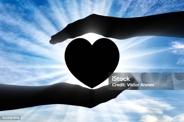 Altruism Silhouette Of Hands Protecting Heart Symbol Stock Photo - Download Image Now