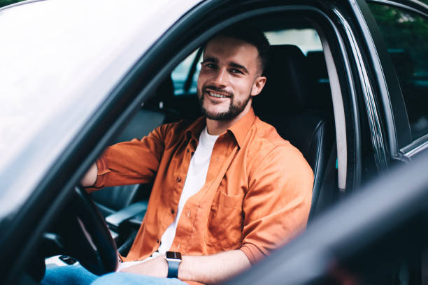 istock Cheerful male driver sitting in car 1433162063