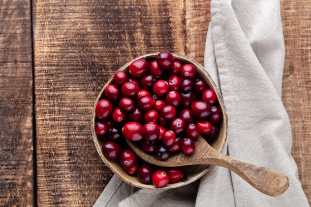 istock Red cranberries on wooden background. Brries in a bowl. 1433162467