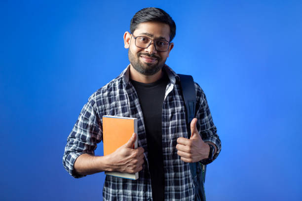 istock Indian student showing thumb up hand gesture. 1433164818