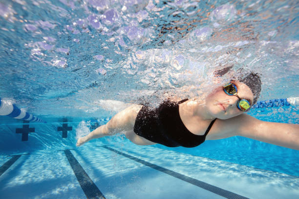 istock Young female swimming during a swim meet 1433164936