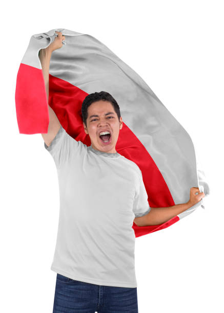Two female friends holding national flag of a country enjoying, watching a soccer match.