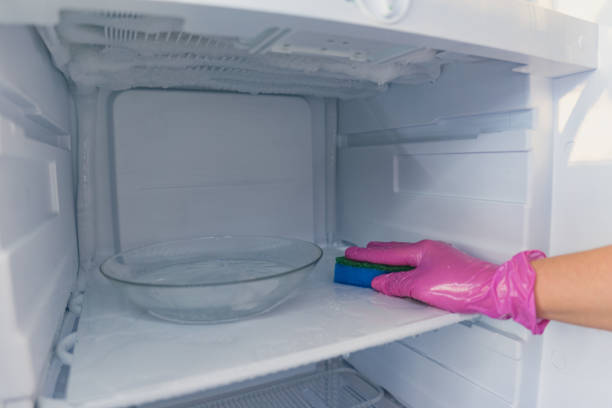 istock A cleaning lady washes the freezer. Cleaning the refrigerator. Selective focus. 1433168299