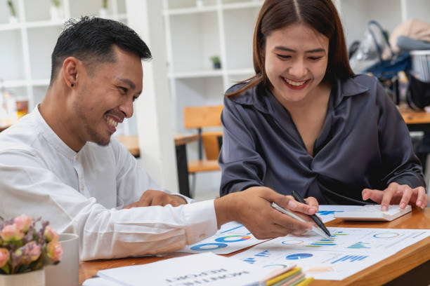istock The company's team of marketers analyzes the company's profits using laptop computer graphs and calculators. 1433168323