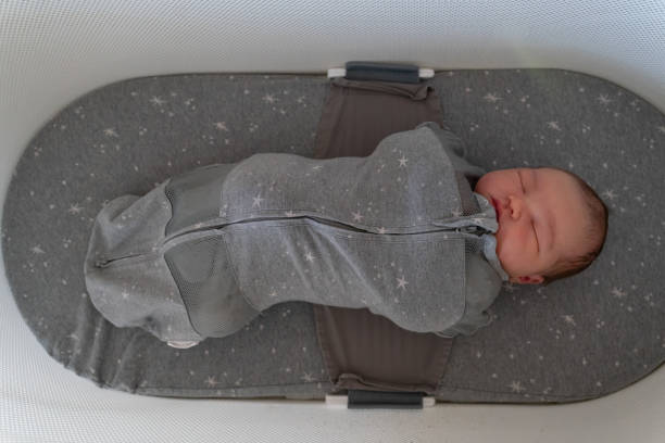 Newborn baby sleeping in bassinet
