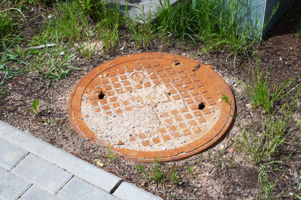istock Old rusty manhole in the grass closeup 1433168429