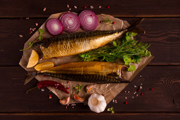 Smoked mackerel, top view, with spices, on a wooden table, no people, selective focus,