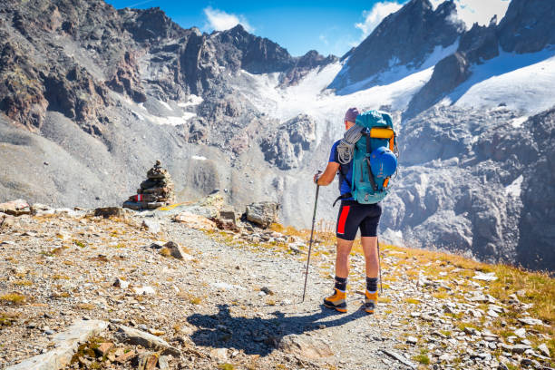istock Mountaineer tourist standing looking Alps mountains ridge view 1433170150