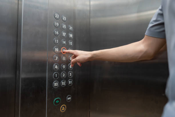 one hand pressing the elevator floor button - claustrophobic imagens e fotografias de stock