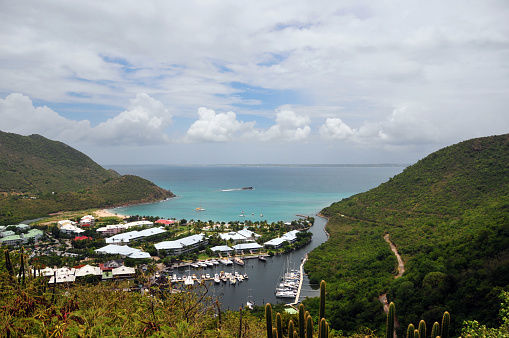 Anse Marcel, Collectivity of Saint Martin / Collectivité de Saint-Martin, French Caribbean: sheltered cove with a sandy beach framed by green hills, hosting luxury hotels and the Marina Port de Lonvilliers - seen from the mountains.