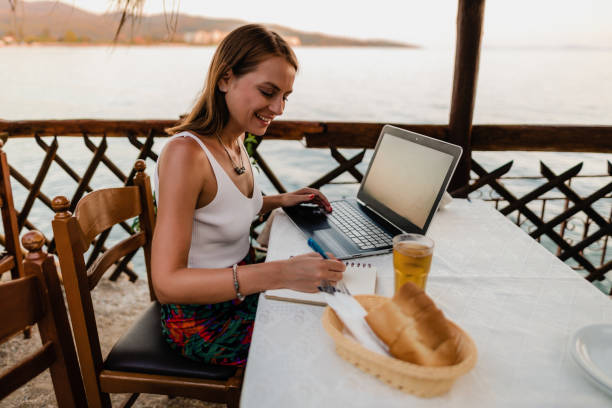 istock Young woman studying in a seaside restaurant in Greece 1433174974