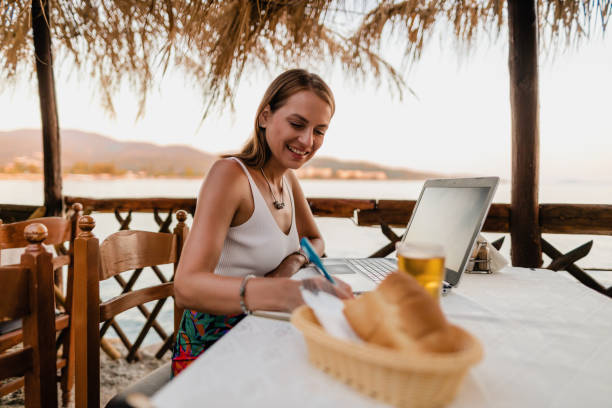 istock Young woman studying in a seaside restaurant in Greece 1433175059