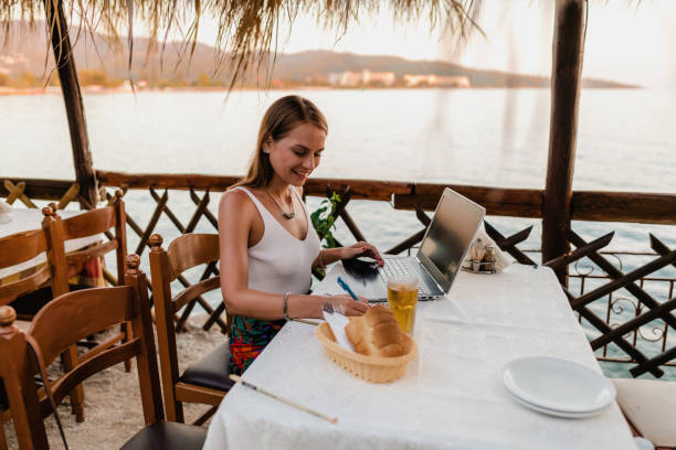 istock Young woman studying in a seaside restaurant in Greece 1433175083