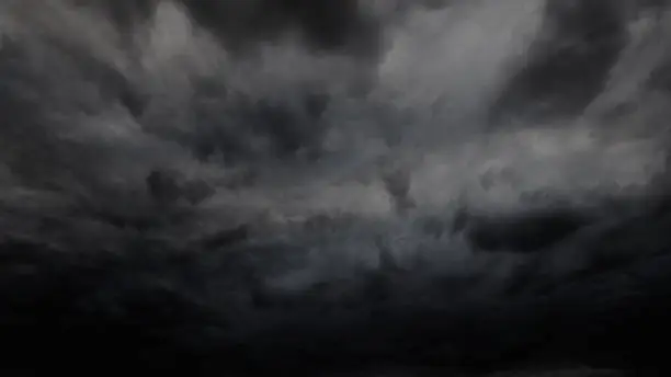 Photo of dark dramatic sky with stormy clouds before rain or snow as abstract background, extreme weather