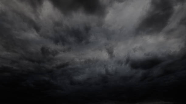 dark dramatic sky with stormy clouds before rain or snow as abstract background, extreme weather - cumulonimbus imagens e fotografias de stock