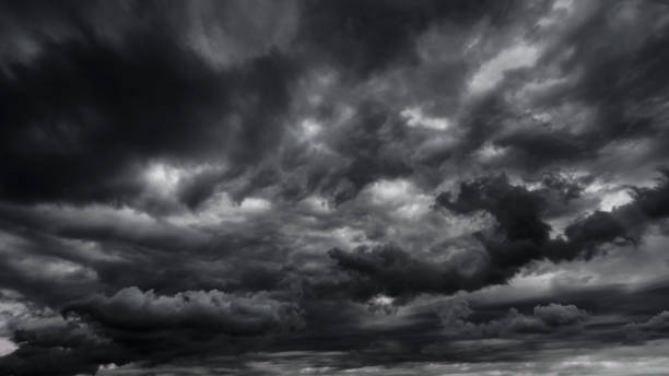 istock dark dramatic sky with black stormy clouds before rain or snow as abstract background, extreme weather, the sun shines through the clouds, high contrast photo 1433177275
