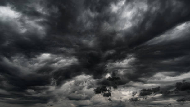 istock dark dramatic sky with black stormy clouds before rain or snow as abstract background, extreme weather, the sun shines through the clouds, high contrast photo 1433177309