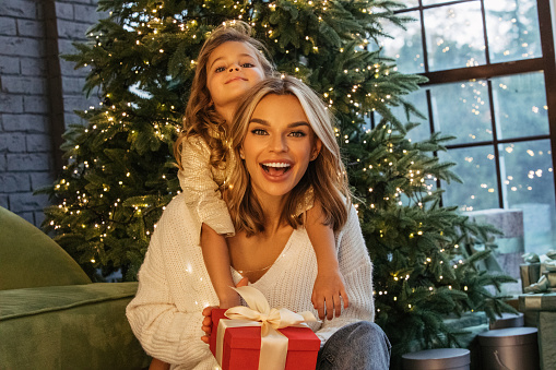 Happy Mother with Baby Child in Christmas atmosphere