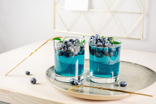 Blueberry gelatin dessert in a glass on a  tray.