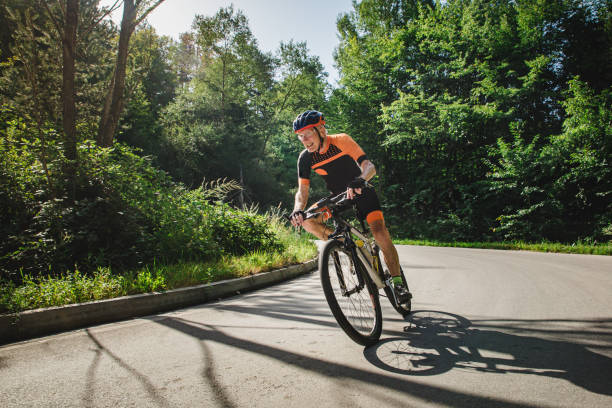 istock Man in his 80's cycling in the mountains 1433184374