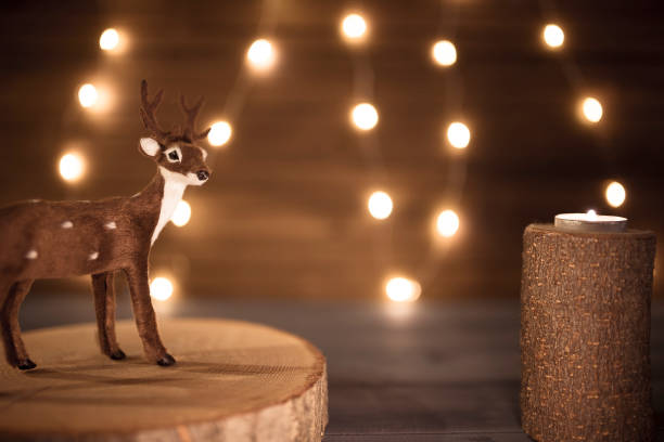 Miniature reindeer with string lights christmas wallpaper. stock photo