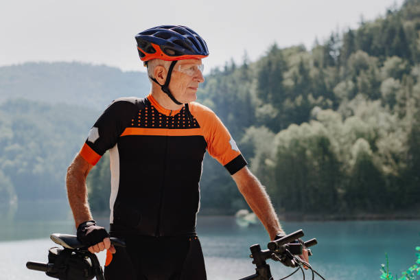 istock Man in his 80's cycling in the mountains 1433186988