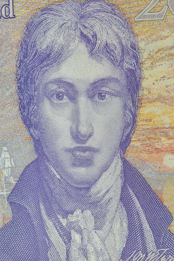 Portrait of English romantic painter, printmaker and watercolourist Joseph Mallord William Turner on British twenty pounds sterling banknote back closeup.