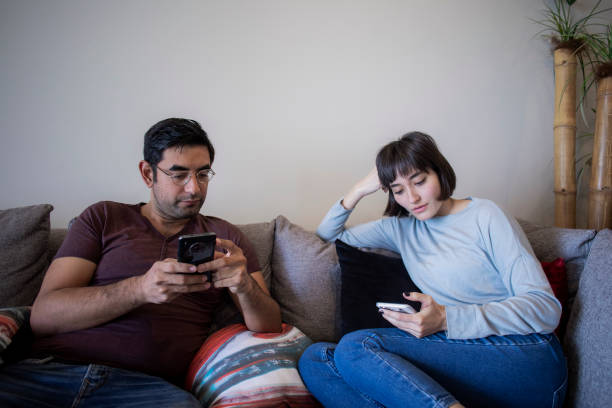 istock couple using the cell phone in the living room 1433190359