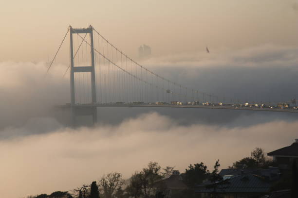 Istanbul in foggy weather Bosphorus and Bosphorus Bridge stuck in fog, autumn weather, Bosphorus Bridge heat haze stock pictures, royalty-free photos & images