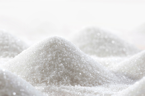 Sugar hills close-up. Refined white sugar in the kitchen.