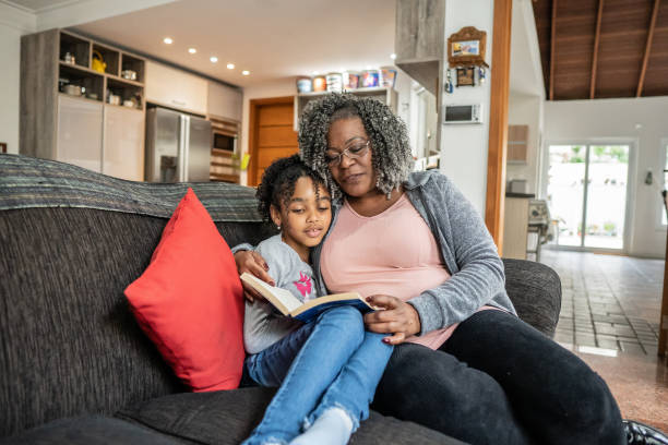 istock Grandmother and granddaughter reading book 1433197197