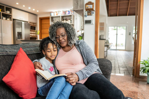 istock Grandmother and granddaughter reading book 1433197219