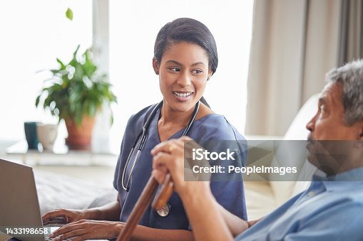 istock Nurse help senior man with internet and laptop on the sofa in a retirement home. Healthcare worker, caregiver or medical professional helping retired man with email and technology in the lounge 1433198658