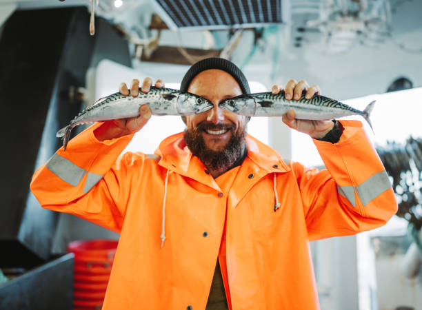 istock Fisherman with fish in front of his eyes 1433200217