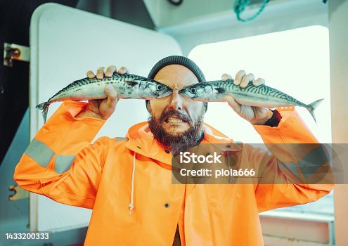istock Fisherman with fish in front of his eyes 1433200333