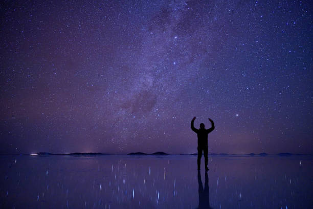 istock Night sky at Salar de Uyuni (Bolivia) with a silhouette person 1433201621