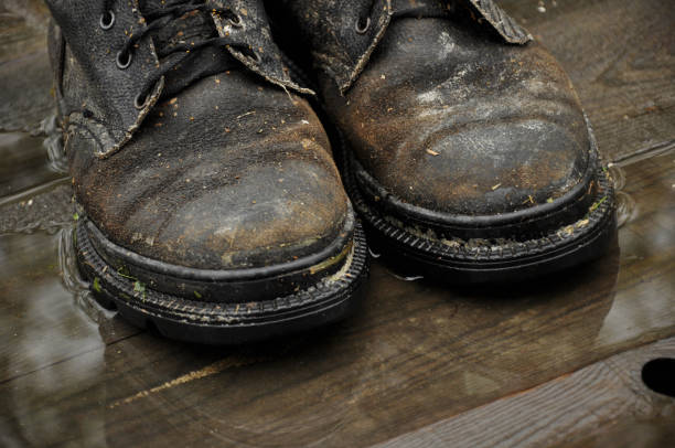 istock Pair of boots on wooden floor boards 1433204384