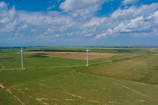 On a wind farm generate electricity in Texas USA, row of windmills is used to generate renewable energy.