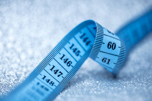 Close-up of tape measure on a sparkling background. Shallow depth of field, space for copy.
